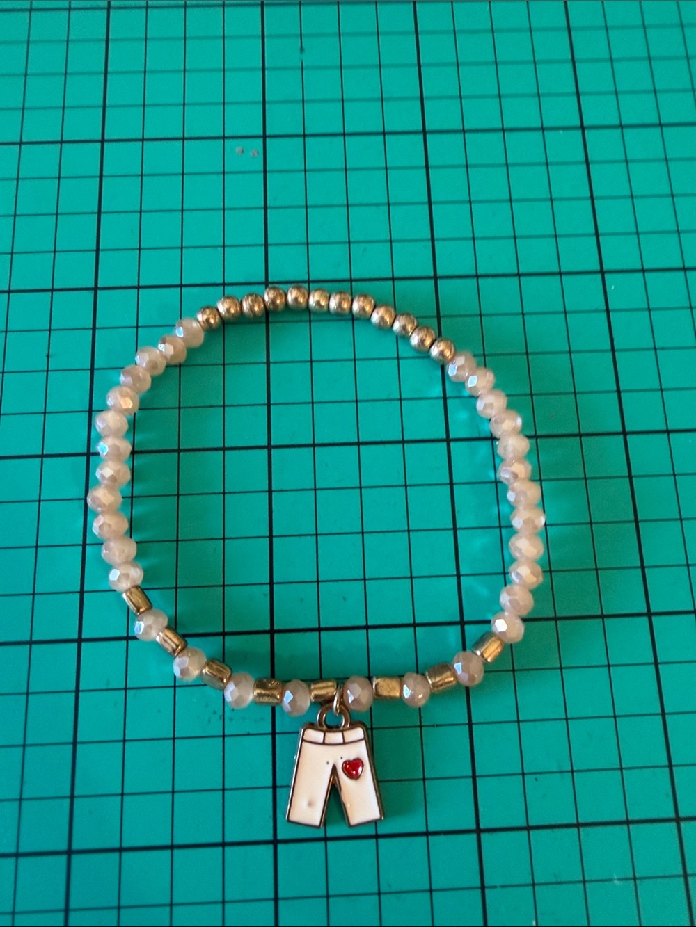 White Beaded Stretch Bracelet with Pants Charm